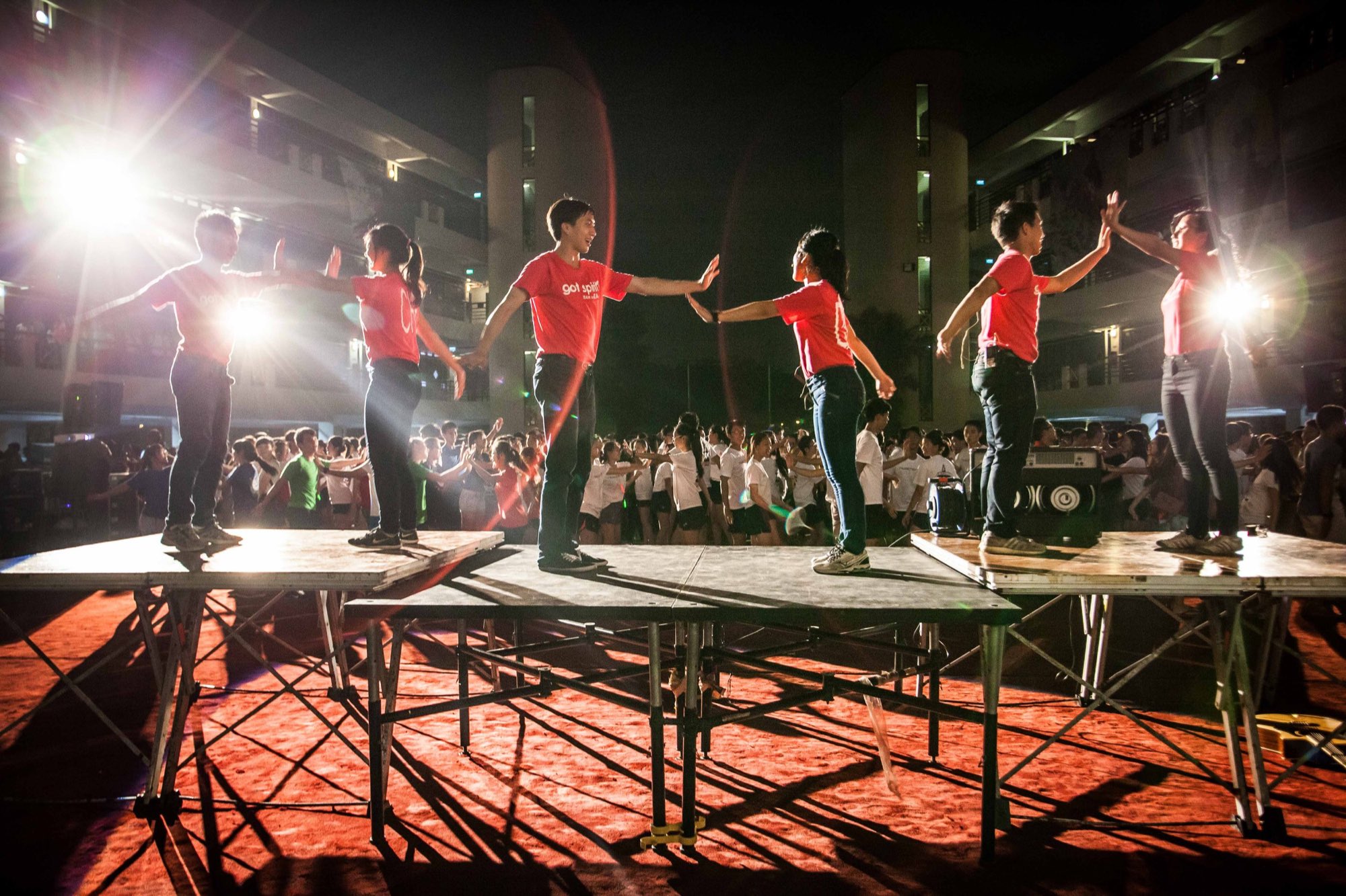 Performers on stage under coloured lights at a company event